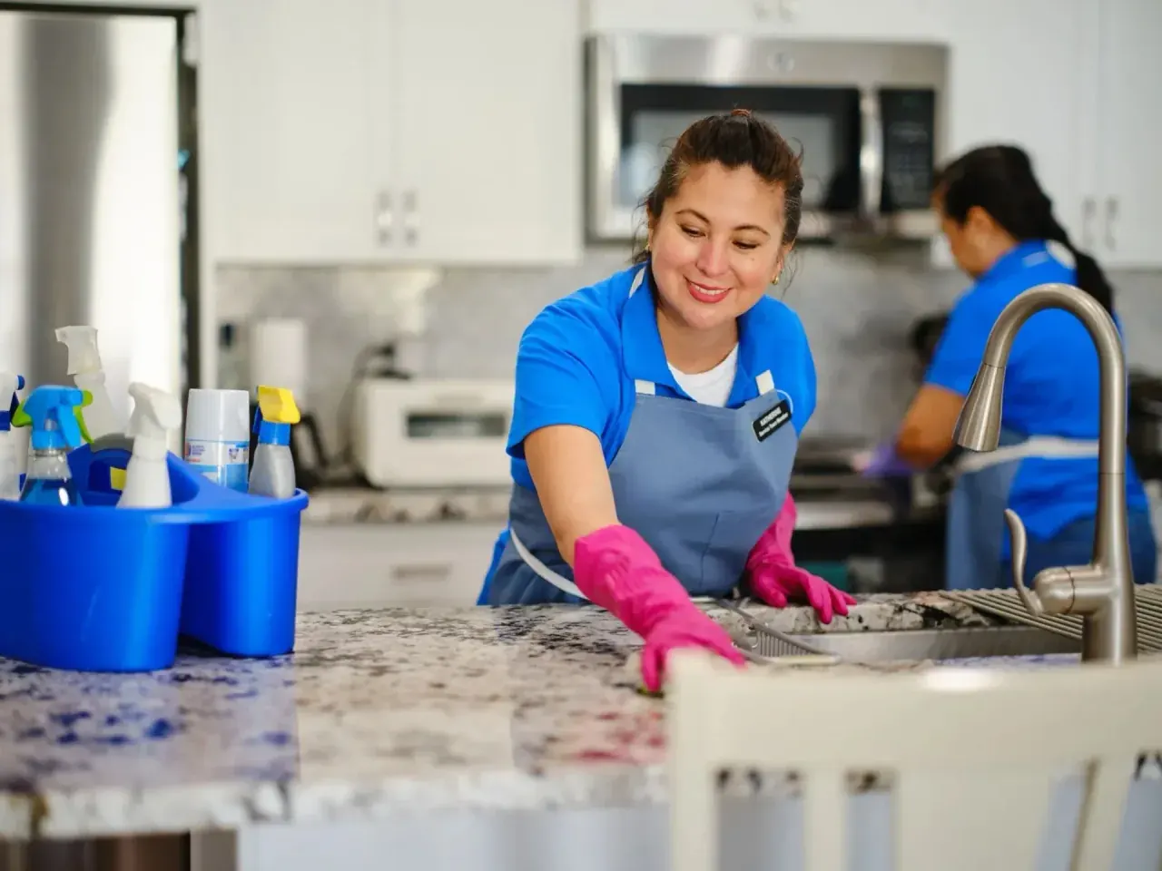 CQD cleaner wiping a commercial kitchen worktop