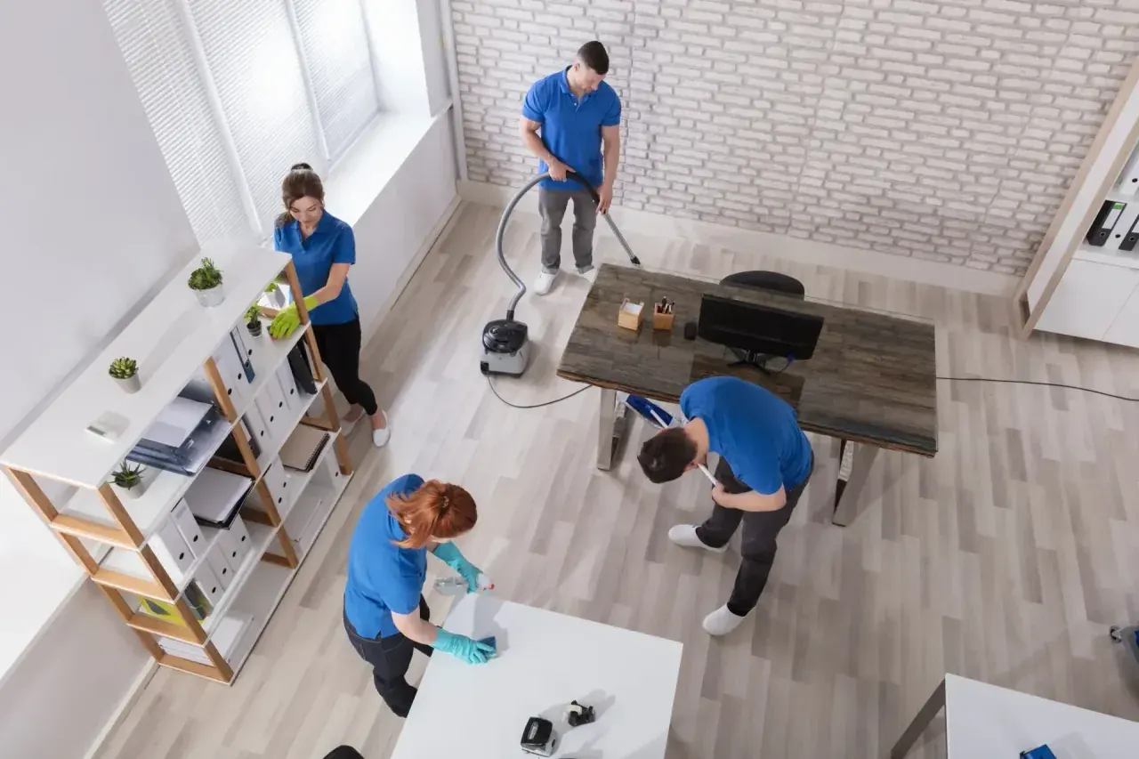 CQD cleaners working methodically across a bright commercial office