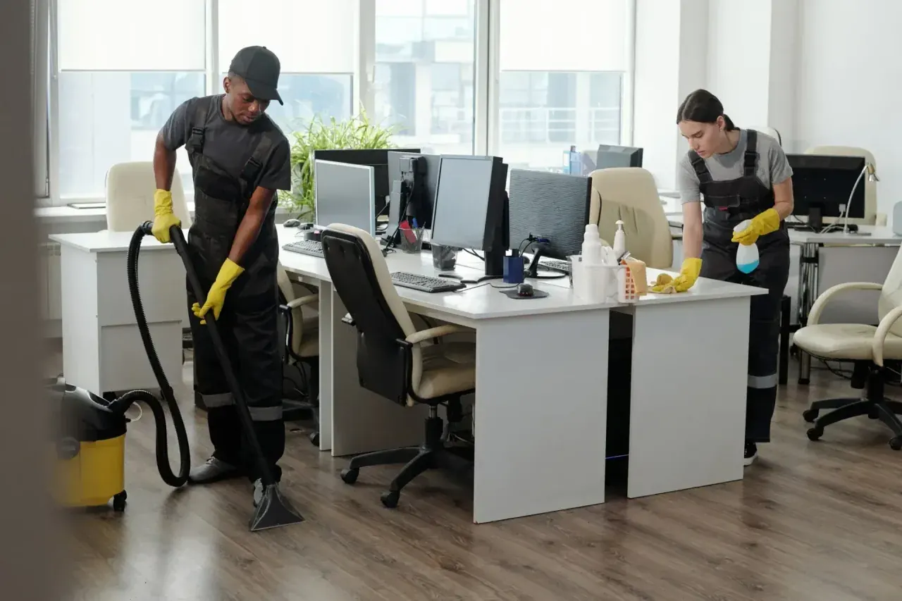 Two CQD cleaners working together in a commercial office